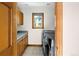 Bright laundry room with modern washer and dryer, built in cabinets, and natural light at 2595 S Harlan Ct, Lakewood, CO 80227