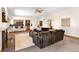 Spacious living room with fireplace, wet bar, and large sectional couch; perfect for entertaining or relaxing at 2595 S Harlan Ct, Lakewood, CO 80227
