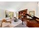 Bright living room with fireplace, piano, large windows, and comfortable seating at 2595 S Harlan Ct, Lakewood, CO 80227