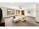 Bright living room with large windows, neutral colors, and a comfortable sofa at 2595 S Harlan Ct, Lakewood, CO 80227