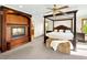 Charming main bedroom with fireplace and four-poster bed, offering a cozy and luxurious retreat at 2595 S Harlan Ct, Lakewood, CO 80227