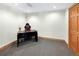 Cozy carpeted home office with wood trim, ample room and bright natural light at 2595 S Harlan Ct, Lakewood, CO 80227