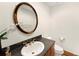 Charming powder room featuring designer mirror, vanity, granite countertop, and elegant fixtures at 2595 S Harlan Ct, Lakewood, CO 80227