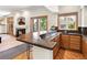 Entertain in a stylish wet bar with wood cabinets, granite countertop, and seamless flow into the living room at 2595 S Harlan Ct, Lakewood, CO 80227