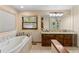 Bathroom with double vanity, soaking tub, and walk-in shower at 9724 E Villasur Ct, Parker, CO 80134