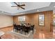 Formal dining room with hardwood floors, large table, and brick accent wall at 9724 E Villasur Ct, Parker, CO 80134