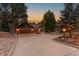 House exterior at dusk with a long driveway at 9724 E Villasur Ct, Parker, CO 80134