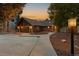 House exterior at dusk, two-car garage, and landscaping at 9724 E Villasur Ct, Parker, CO 80134