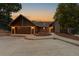 House exterior at sunset, featuring a two-car garage and landscaping at 9724 E Villasur Ct, Parker, CO 80134