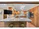 L-shaped kitchen with granite counters and wood cabinets at 9724 E Villasur Ct, Parker, CO 80134