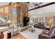 Spacious living room featuring a stone fireplace and large windows at 9724 E Villasur Ct, Parker, CO 80134