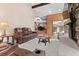 Living room with a stone fireplace, showing a view into the dining area at 9724 E Villasur Ct, Parker, CO 80134