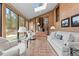 Sunroom with tiled floors, sofas, and views of the backyard at 9724 E Villasur Ct, Parker, CO 80134