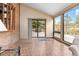 Sunroom with tile floor, sliding glass door to deck, and views of backyard at 9724 E Villasur Ct, Parker, CO 80134