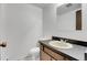 Powder room showcasing a wood vanity with light countertop and hardware at 12341 E Cedar Cir, Aurora, CO 80012