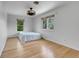 Bright bedroom with hardwood floors, dual windows, and neutral decor at 12341 E Cedar Cir, Aurora, CO 80012