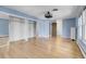 Large bedroom featuring hardwood floors, natural light, closet, and blue walls at 12341 E Cedar Cir, Aurora, CO 80012
