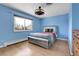 Comfortable bedroom featuring blue walls, hardwood floors, and a cozy window bench at 12341 E Cedar Cir, Aurora, CO 80012