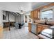 Open kitchen with tiled floors, a dining area, and modern appliances at 12341 E Cedar Cir, Aurora, CO 80012