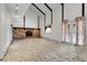 Living room with a stone fireplace, high ceilings with beams, and doors to the backyard at 12341 E Cedar Cir, Aurora, CO 80012