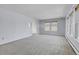 Spacious living room with light walls, carpet, and large windows at 12341 E Cedar Cir, Aurora, CO 80012