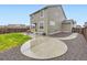 Large backyard with a spacious patio area, privacy fence, and rock landscaping at 14687 Eudora St, Thornton, CO 80602