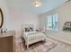 Cozy bedroom featuring a spindle bed, a window and rug to add personality to the space at 14687 Eudora St, Thornton, CO 80602