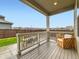 Outdoor deck with patio furniture and a view of the fenced backyard at 14687 Eudora St, Thornton, CO 80602