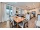 Dining area with view into kitchen, seamlessly blends a kitchen and living space with a large sliding door at 14687 Eudora St, Thornton, CO 80602