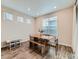 Bright dining area with ample windows, wood table and bench seating, illuminated by recessed lighting at 14687 Eudora St, Thornton, CO 80602