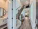 Spacious entryway featuring wood floors, staircase and view into a living area, offering a warm welcome at 14687 Eudora St, Thornton, CO 80602