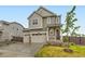 Charming two-story home featuring a two-car garage and inviting front porch, perfect for suburban living at 14687 Eudora St, Thornton, CO 80602