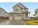 Inviting two-story home boasts a well-manicured lawn, attached two-car garage, and a welcoming front entrance at 14687 Eudora St, Thornton, CO 80602