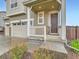 Inviting front entrance with white porch and brown door provides curb appeal and a sense of arrival at 14687 Eudora St, Thornton, CO 80602