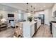 Open-concept kitchen with a large island, stainless steel appliances, and access to a comfortable living room at 14687 Eudora St, Thornton, CO 80602