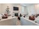 Cozy living area with fireplace, wood floors, and plush sofas, perfect for relaxing or entertaining guests at 14687 Eudora St, Thornton, CO 80602