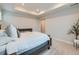 Bright main bedroom suite featuring a comfortable bed, side table and a plant to add nature to the space at 14687 Eudora St, Thornton, CO 80602