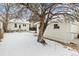 Large backyard with detached garage and mature trees in winter at 2167 S Emerson St, Denver, CO 80210