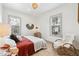 Bright bedroom featuring a cozy sitting area and hardwood floors at 2167 S Emerson St, Denver, CO 80210