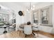 Bright dining area with a round wooden table and view into the living room at 2167 S Emerson St, Denver, CO 80210