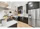 Modern kitchen with stainless steel appliances and marble countertops at 2167 S Emerson St, Denver, CO 80210