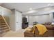 Basement Gathering room with carpet, a TV, neutral colored paint and stairs to another level at 23634 Broadmoor Dr, Parker, CO 80138