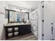 Updated bathroom with granite counters, modern vanity, and decorative shower curtain at 23634 Broadmoor Dr, Parker, CO 80138