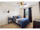 Comfortable bedroom with ceiling fan, side table and carpet at 23634 Broadmoor Dr, Parker, CO 80138
