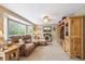 Inviting living room with a plush sectional, bay window, and entertainment center at 23634 Broadmoor Dr, Parker, CO 80138