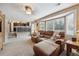 Comfortable living room with a plush reclining sectional sofa, large windows, and open access to the kitchen at 23634 Broadmoor Dr, Parker, CO 80138
