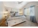 Bright main bedroom features vaulted ceiling, ceiling fan, and large window with sheer curtains at 23634 Broadmoor Dr, Parker, CO 80138