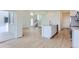 Open floor plan with bright living room, kitchen island, and stainless steel appliances at 1284 S Algonquian St, Aurora, CO 80018