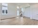 Bright living room boasts large windows, wood-look floors, and access to the staircase at 1284 S Algonquian St, Aurora, CO 80018