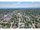 Expansive aerial view of a neighborhood with lush green trees, buildings, and a glimpse of mountains in the distance at 4506 N Vrain St, Denver, CO 80212